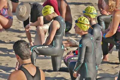Swim Team in Solidarity kneeling at The Inkwell - Lifeguard Tower 20 closeup